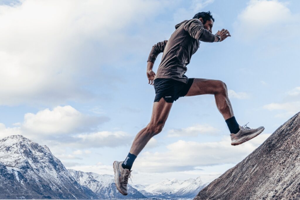 man running up a mountain